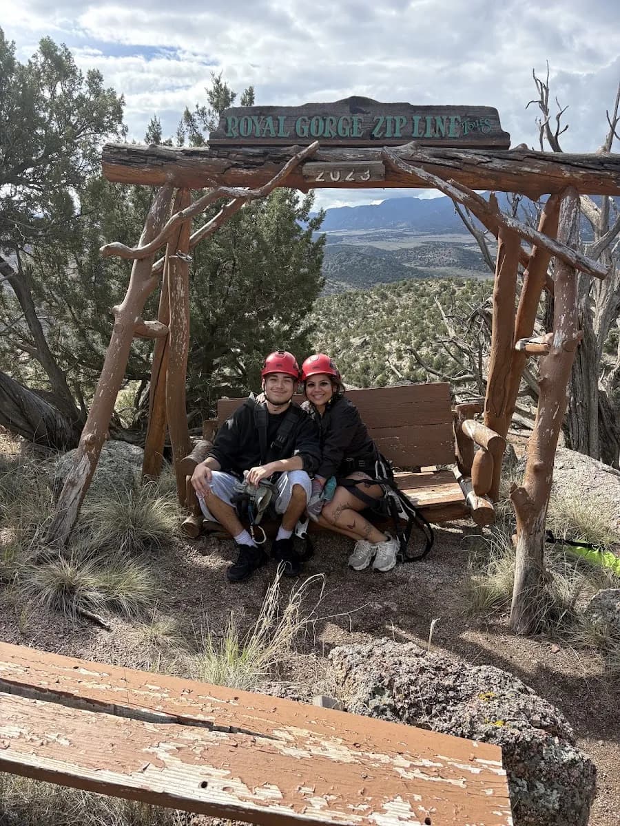 Guest photo by Reshma on Google: a smiling couple in helmets on the Royal Gorge Zip Line bench